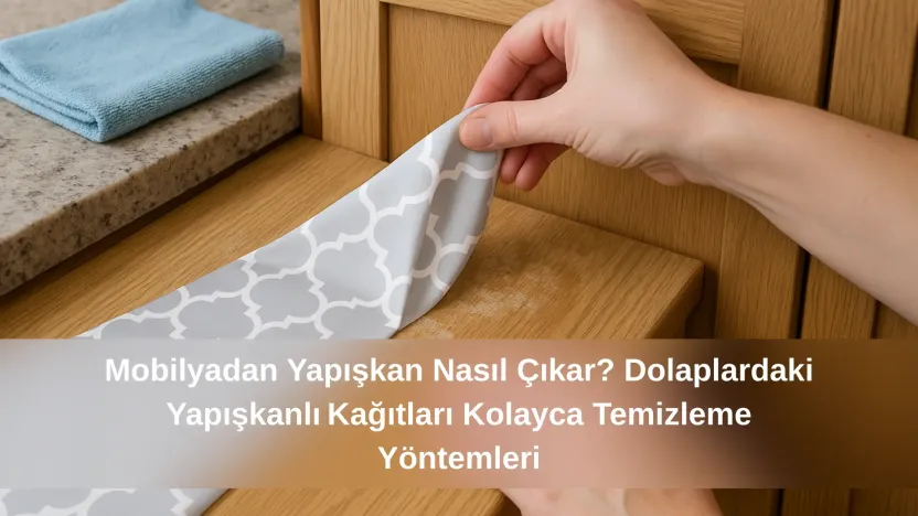 Ahşap dolap kapağından yapışkanlı kağıdın elle sökülme anı, yüzeyde hafif yapışkan kalıntıları görülüyor